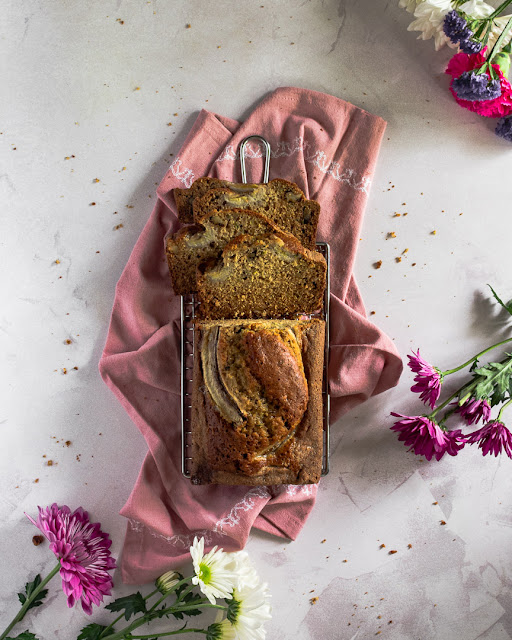 Zucchini Banana Bread on cooling rack framed in pink napkin and spring flowers