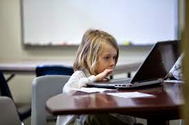 little girl working on a laptop