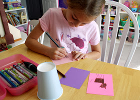 The girls in our Journey group are decorating paper cups with art that represents their favorite animals. Tessa chose to decorate her cup with drawings of cats.