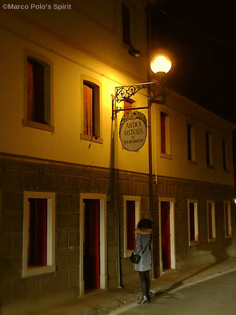 lamp post and sign outside the restaurant