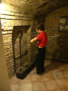 Reading one of the displays in the Museo Della Tortura Siena, Tuscany, Italy