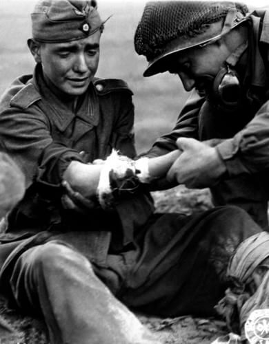 12 Powerful Images That Prove There's Still Kindness In The World - An American GI is treating a young German soldier in pain in 1944.