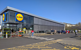 Photo of shoppers queuing 2m apart outside the Lidl store in Maryport, Cumbria, UK