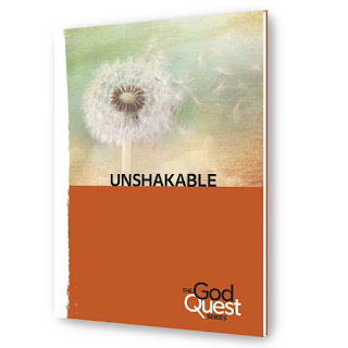 Free Devotional -Unshakabke image shows abook with black and white floral pirint on the top half of the cover and orange on the bottom half