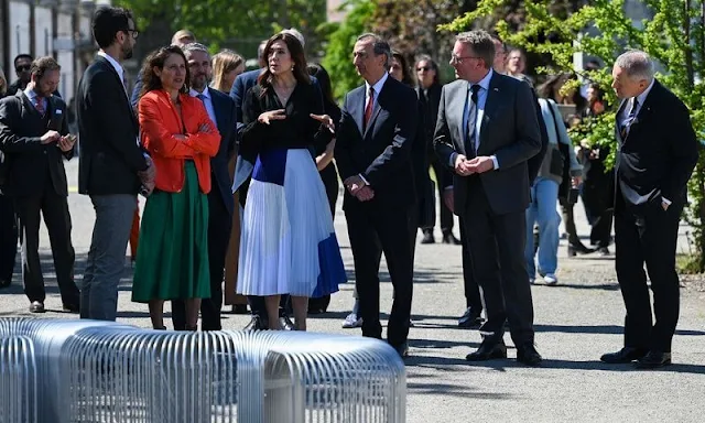 Crown Princess Mary wore a pleated chiffon midi skirt by Designers Remix, and a black v-neck silk blouse by Julie Fagerholt