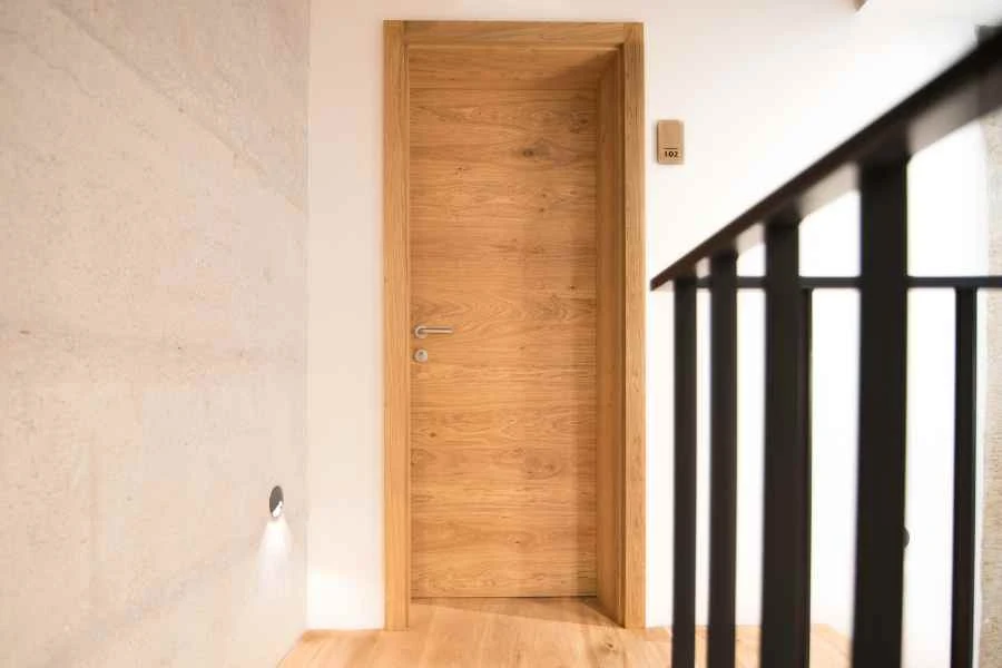 A corridor with an oak door