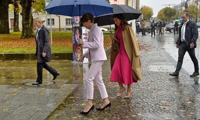 Carolina Herrera double-faced camel beige wool coat. Moises Nieto fuchsia dress. Furla 1927 floral pattern mini handbag