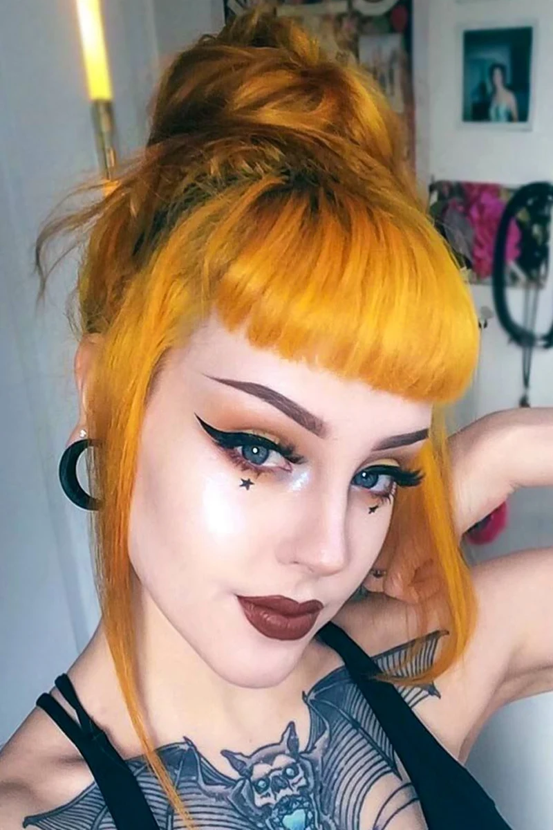 selfie of a young woman with punk haircut, mustard hair and pin-up makeup look