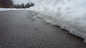 the separation of snow and ice from the road surface