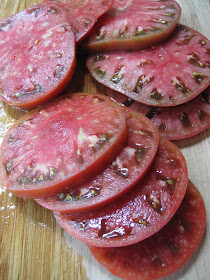 several slices of tomatoes on cutting board 