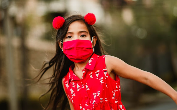 Montessori child wearing a mask. Photo by Helena Lopes from Pexels