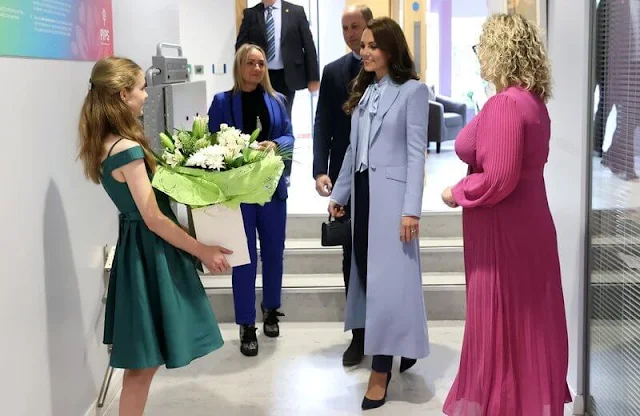 Princess Catherine wore a new soft blue bow silk blouse by Winser London. Gianvito Rossi navy suede pumps. Missoma Jewellery