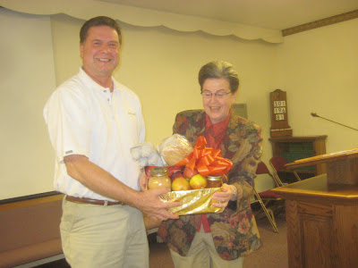 Rachel Olsen presents gift to Roland Lee at Richfield Art Talk