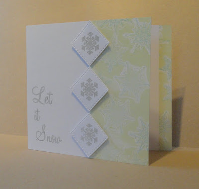 Christmas card with green and blue snowflake pattern on right and Let it Snow sentiment