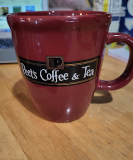 Photo of a Peet's coffee mug, maroon with Peet's logo