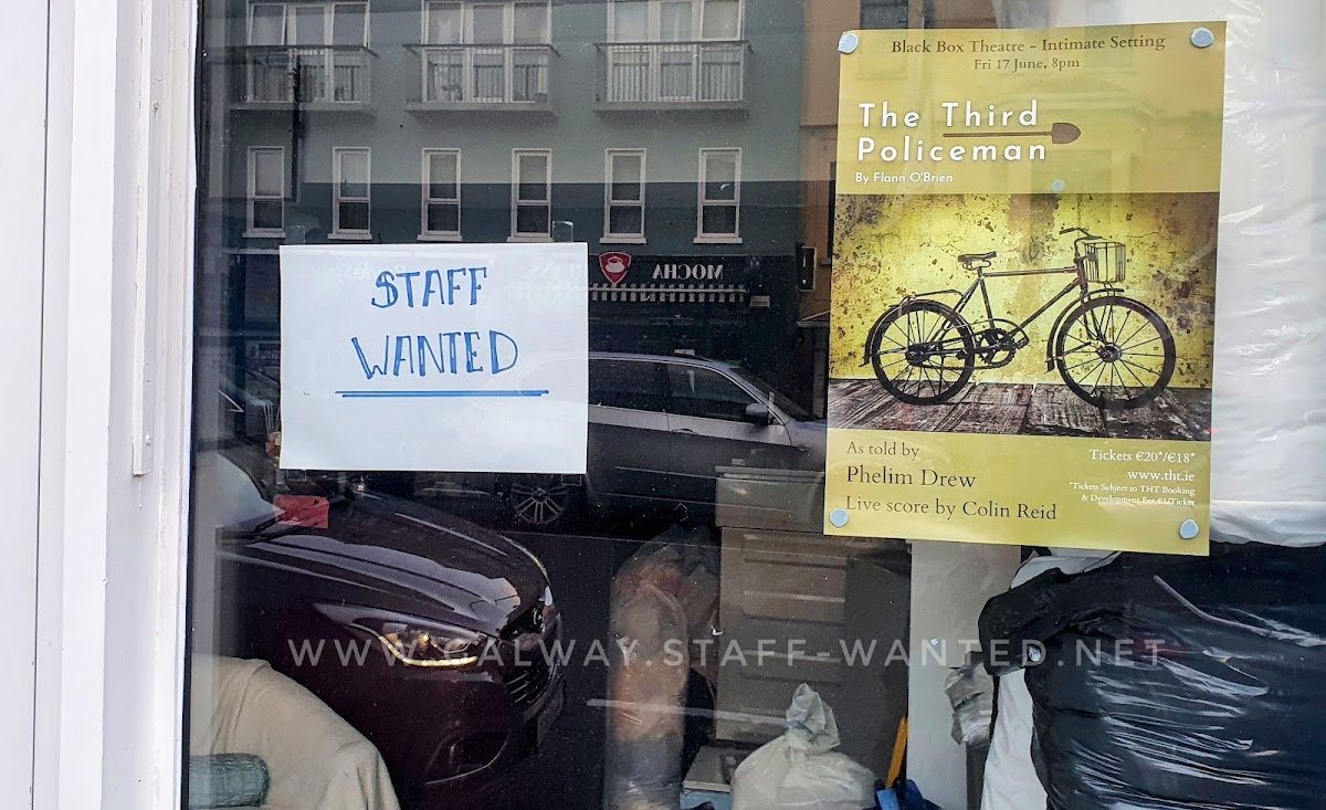 Shop window with a staff-wanted sign, and a poster for a long-since-finshed play in the Black Box Theatre, The Third Policeman as told to Pheilim Drew