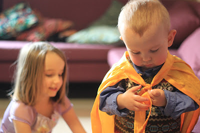 child wearing a cape