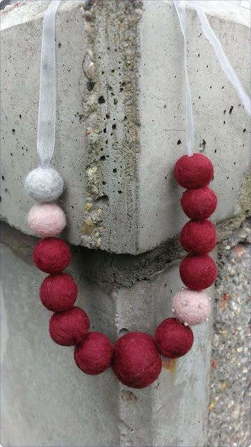 Red felted necklace with ribbon hanging