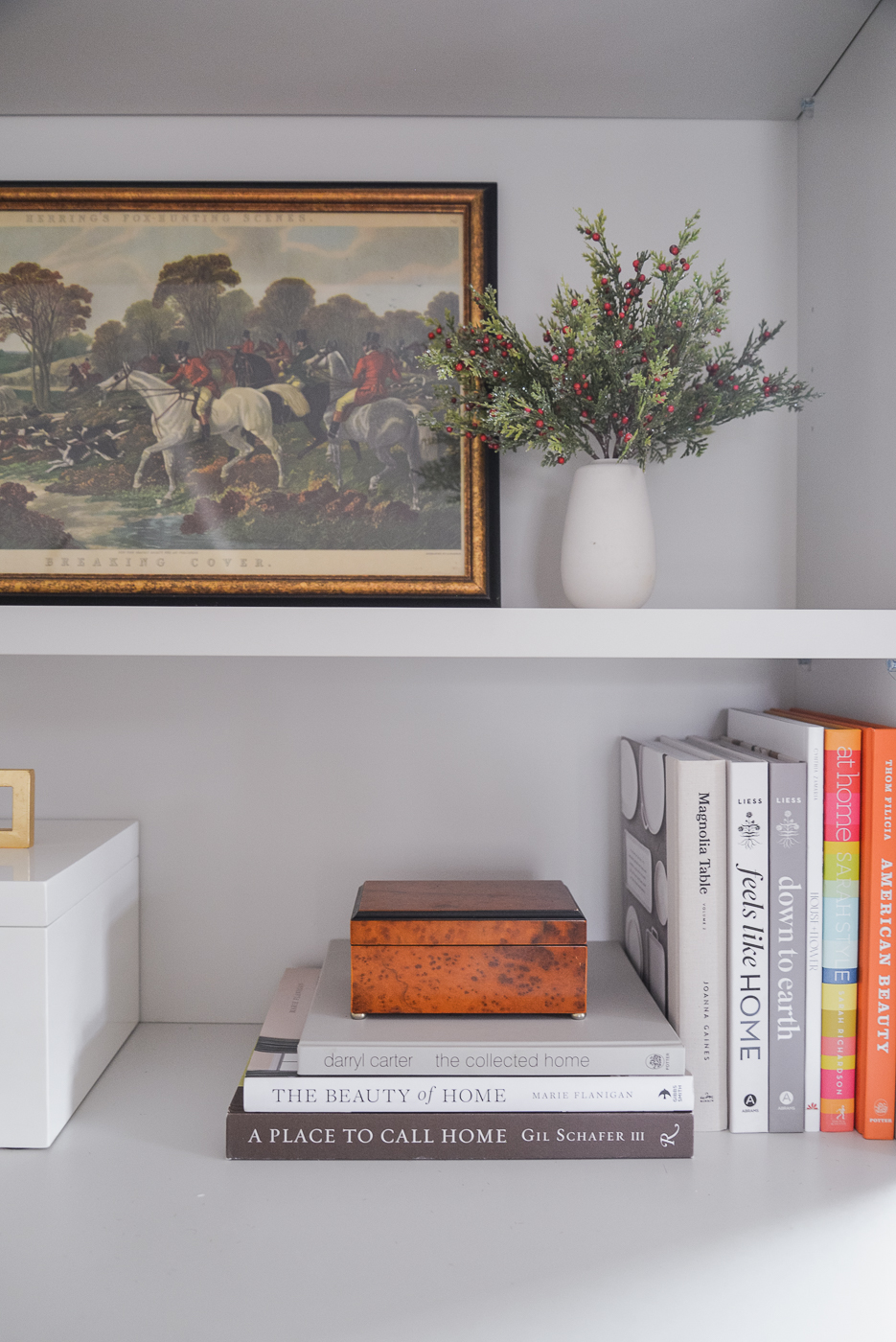 living room book case styling with faux plants books and wood box
