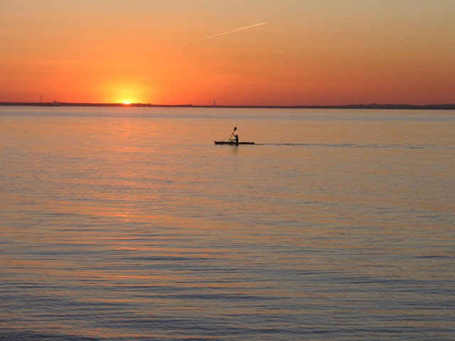 Canoeing on the sea with stunning sunset.