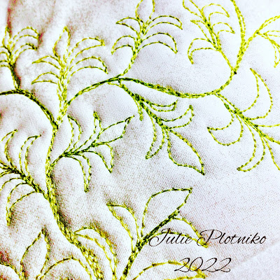 Machine stitching of free flowing ferns in bright green thread