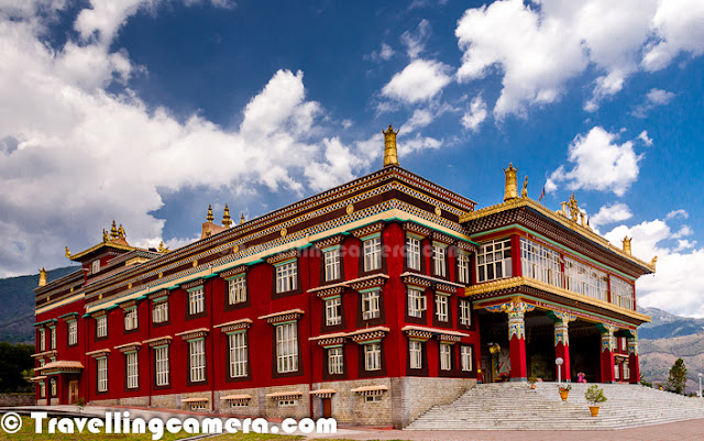 Often an unplanned detour opens a whole new world to you, and sometimes a chance visit to an unknown place can change the entire mood of your travel. A traveler will easily identify with these feelings. Not many people include the Dzongsar Khyentse Chökyi Lödrö Institute in their itineraries when they visit Himachal pradesh. In fact, very few people are even aware of its existence.    But while travelling on the pretty, narrow roads through the tiny town of Chauntra in the Mandi district of Himachal Pradesh, you do not realize when the dissonance of the everyday market scenes is replaced by the harmony one often associates with spiritualism.  For a long time, you travel through fragrant fields and houses, from where Tibetan faces gaze at you with such good-natured familiarity that you feel that the land and the air are both opening their arms to you. As you leave the houses behind, a blissful anticipation grows in your heart and a red building finally breaks through the horizon and gradually begins to take a shape. The colour red isn’t usually associated with peace and tranquility. But one look at this building and your perception of red changes forever. The majestic building, which is the monastery, presides over the sprawling grounds, surrounded by the green hills and resonant with the chirping of birds and the gushing of wind in the trees. In the circular dormitory, a lone monk sits gainst the pillar, engrossed in his scholarly exploration of the theories of Buddhism, or perhaps English, which is taught in the institute with a vision to enable the Buddhist teachers to spread the teachings of Buddha across cultural and linguistic borders. There is such concord between the Institute and the surroundings that it is difficult to imagine what the landscape would have looked like before the institute was constructed hardly a decade back. The Tibetan way of life seems so prevalent that you have to force yourself to remember that the institute was inaugurated as recently as 2004, by His Holiness the Dalai Lama and severalther lamas and dignitaries. While sitting on the steps that lead up to the entrance of the monastery or while clicking pictures, it is easy to lose yourself in the serene surroundings. But it is important to remember that this complex isn’t really on the tourist circuit and is primarily an educational institute so there may be a chance that the tourists may not be granted permision to enter on a particular day or at a specific time. But at other times, if you are fortunate, you may even get an opportunity to enter the monastery and walk barefoot along the wooden desks where it is easy to conjure up the images of mystical monks engaging in their holy discourse. The symphony of colours all around carries you up to the magnificent, imposing statue of Buddha, surrounded by intricately carved leaves and golden Buddhas in various poses. Even though this encounter doesn’t come as a surprise, it still retains the power to inspire you with awe and, if your mind is receptive, a chance to realize how miniscule we actually are in the larger scheme of things. One leaves this place either speechless or on a spiritual high that only a long, meaningful interaction with nature can induce. 