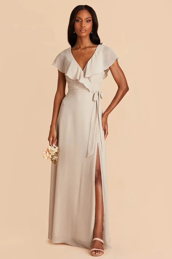 a beautiful bridesmaid in a beige minimalist dress posing for the camera