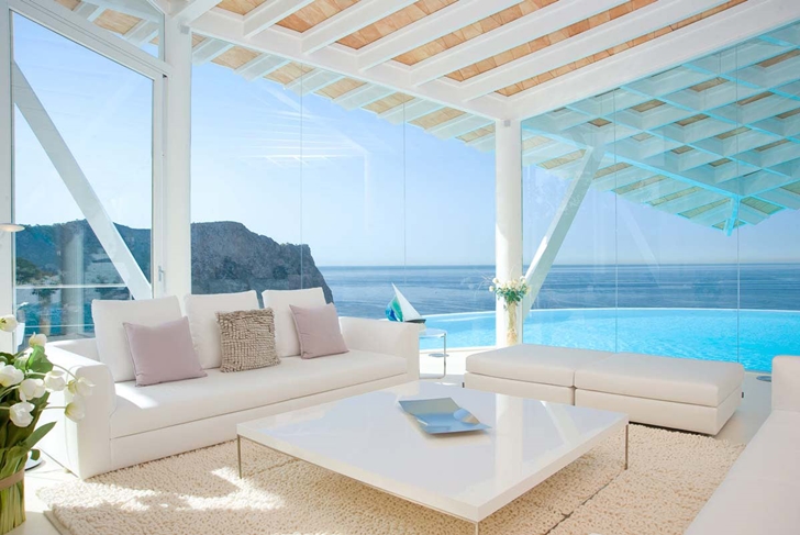 Living room of Mediterranean villa in Mallorca by Alberto Rubio with glass walls 