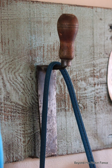 Repurposed Junk Coat Hook using a potato masher, pulley, trowel, door loock and cake server as hooks with reclaimed wood http://bec4-beyondthepicketfence.blogspot.com/2014/01/repurposed-junk-coat-hook.html