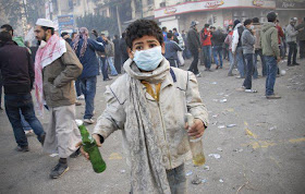 Arab Revolution Egypian Boy Holds Two Molotov Cocktails During Clash With Egyptian Riot Police in Cairo