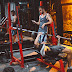 Sporty fitness trainer and man lifting barbell