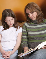 NAMC montessori guide to parent faculty resource center reading a book with girl