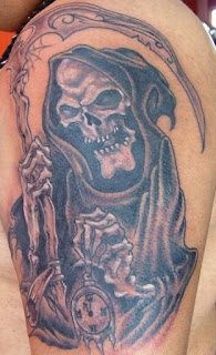 Death tattoo covering the shoulder and the arm: Grim Reaper holding a timepiece