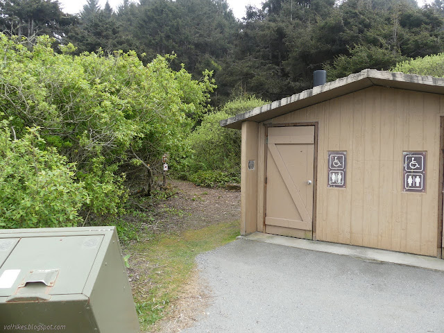 vault toilet with a trail around the back