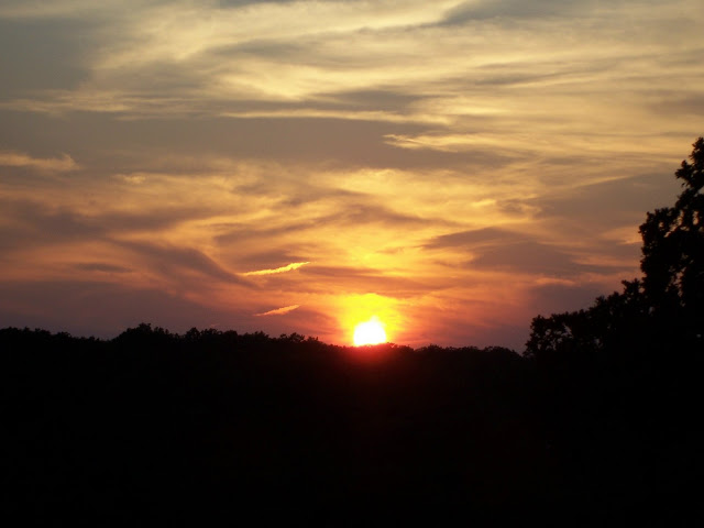 A mauve and peach sunset behind the ridge.