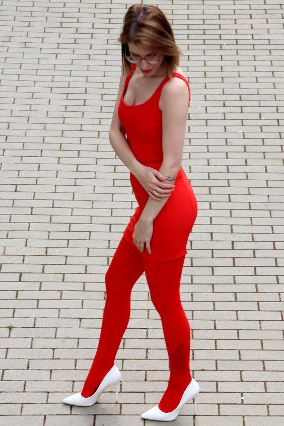 Pretty woman in red dress, red tights and white pumps