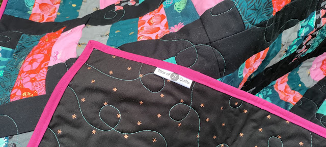 Satin quilt label sewn into the quilt binding