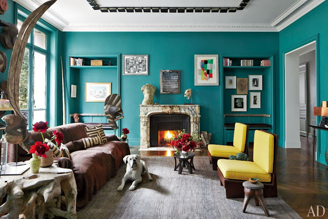 Living room in Stefano Pilati of Zegna's Paris duplex with turquoise walls and yellow Frank Lloyd Wright chairs