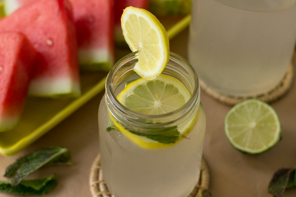 A mason jar filled with lime juice with a hint of mint.