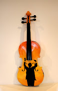 The original student grade violin with the strings and other violin stuff .