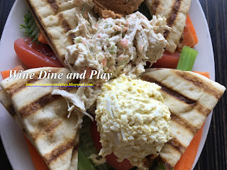 The Tri salad at The Three Birds Tavern in St. Petersburg, Florida is a healthier choice of greens on flatbread with hummus, egg salad, and chicken salad.