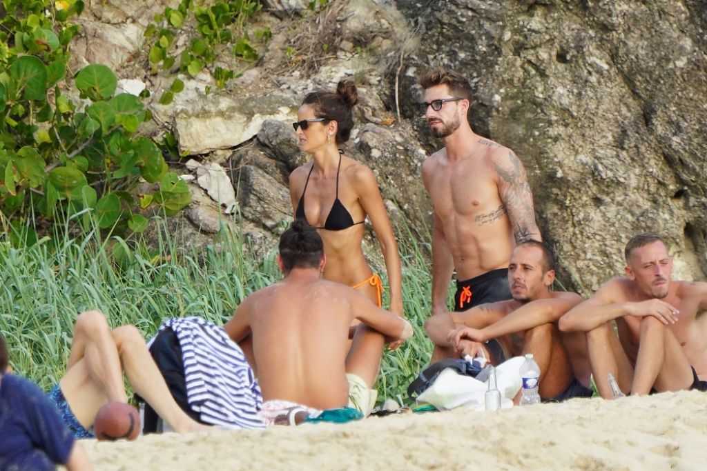 Izabel Goulart, showed off her figure by wearing a tiny bikini on the beach as they relaxed on holiday.