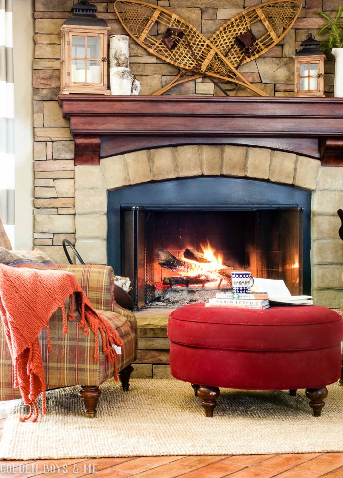 Snowshoe winter mantel decor on stone fireplace