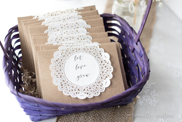 Rustic and romantic spring bridal shower | Seed packet take home favors in kraft envelopes decorated with a paper doily printed with "let love grow" | personallyandrea.com