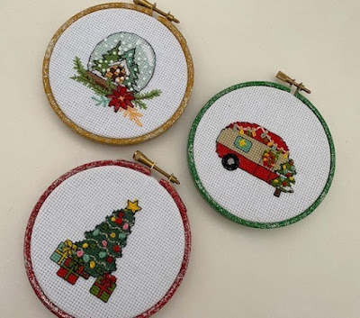 Christmas mini cross stitch designs framed in painted embroidery hoops