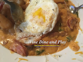 The shrimp and grits with fried eggs, andouille sausage and creole seasoning at the Chill Restaurant And Bar in St Pete Beach, Florida