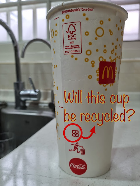 The mobius loop printed on a paper cup trick us to believe that this cup will be recycled.