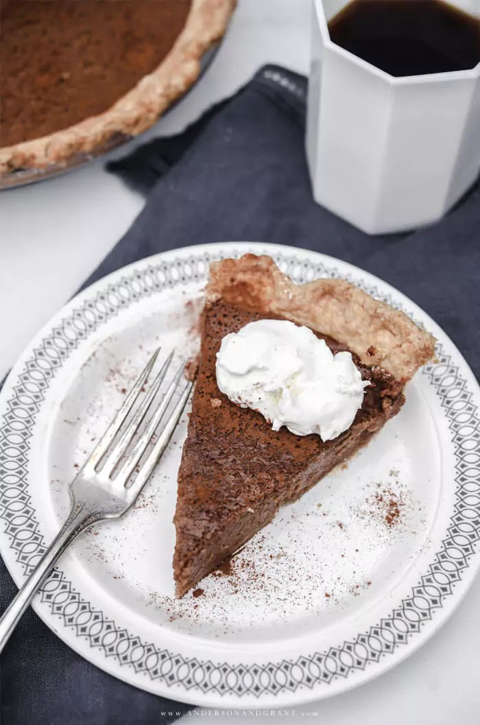Apple Butter Pie Slice topped with whipped cream with coffee