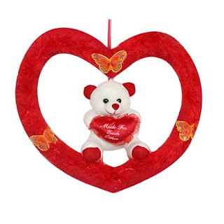 Cute White and Red Teddy Bear sitting in a red heart shaped ring ideal for Teddy Bear day 2020
