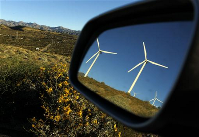 wind turbines reflected in a car mirror